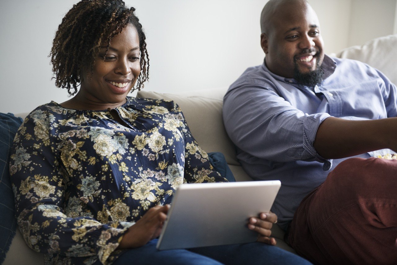 A couple enjoying digital insurance services at home